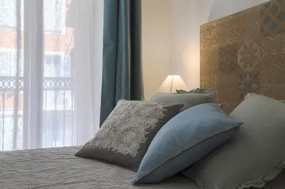 a bedroom with a bed with pillows and a window at MY CASA - CASSINI GT - 1 bedroom - Balcony - Place Garibaldi in Nice