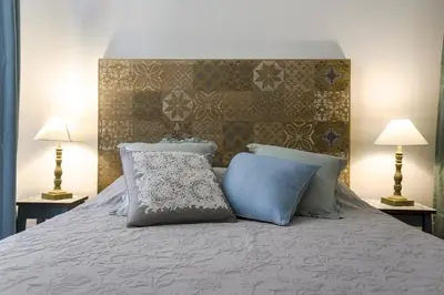 a bed with two pillows on it with two lamps at MY CASA - CASSINI GT - 1 bedroom - Balcony - Place Garibaldi in Nice