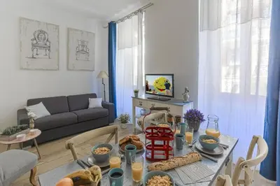 a living room with a table with food on it at MY CASA - CASSINI GT - 1 bedroom - Balcony - Place Garibaldi in Nice