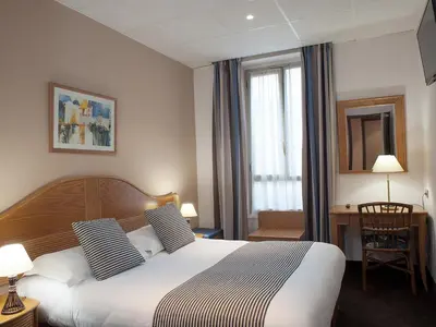a hotel room with a bed and a window at Hôtel Esprit d'Azur in Nice
