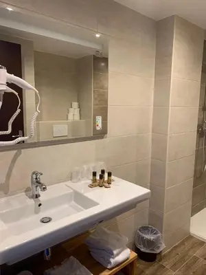 a bathroom with a sink and a mirror at Hôtel Esprit d'Azur in Nice