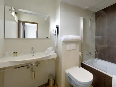 a bathroom with a toilet and a sink and a shower at Hôtel Esprit d'Azur in Nice