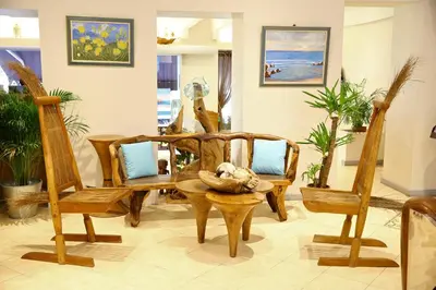 a living room with wooden chairs and a table at Hôtel Esprit d'Azur in Nice