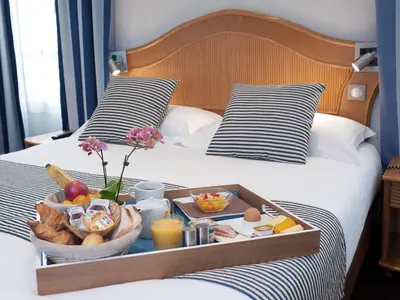 a tray of food on a bed with food at Hôtel Esprit d'Azur in Nice