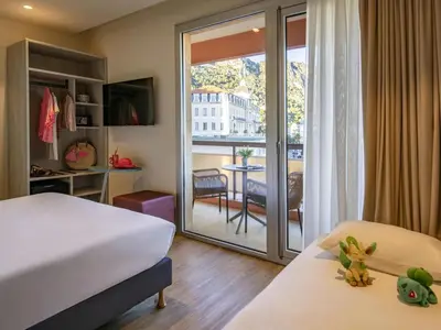 a living room with a couch and a table at ibis Styles Beaulieu sur Mer in Beaulieu-sur-Mer