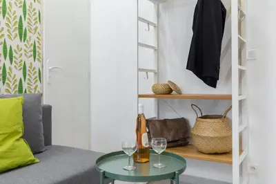 a living room with a green table and wine glasses at Casa Madere- Idéal Couples - Central & cosy -Train station - Tram & Supermarkets-Balcony- Washing-machine-AC in Nice