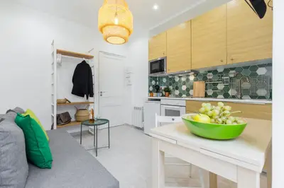 a kitchen with a bowl of fruit on a table at Casa Madere- Idéal Couples - Central & cosy -Train station - Tram & Supermarkets-Balcony- Washing-machine-AC in Nice