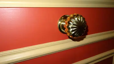 a gold door knob on a red wall at Residence Share Inn in Nice