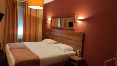 a hotel room with a bed and a mirror at Residence Share Inn in Nice