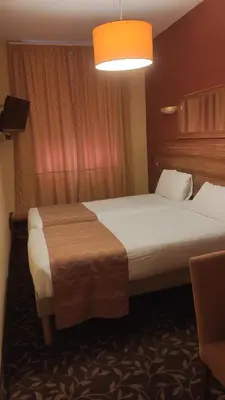 a hotel room with two beds and a light at Residence Share Inn in Nice