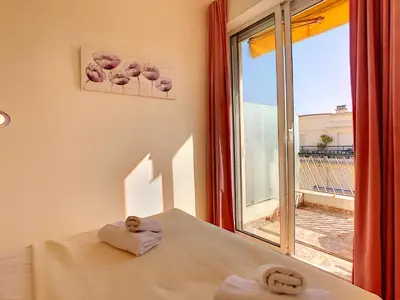 a bedroom with a bed and a window with a view at Nestor&Jeeves - GIBRALTAR TERRASSE - Central - By sea - Pedestrian zone in Nice