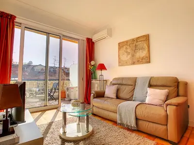 a living room with a couch and a large window at Nestor&Jeeves - GIBRALTAR TERRASSE - Central - By sea - Pedestrian zone in Nice