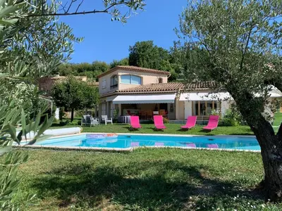 a villa with a swimming pool and pink chairs at Bed & Breakfast Les LILLAS in Saint-Jeannet
