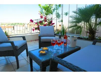 a table with glasses of wine and a plate of food at Val Roya Terrasse in Nice