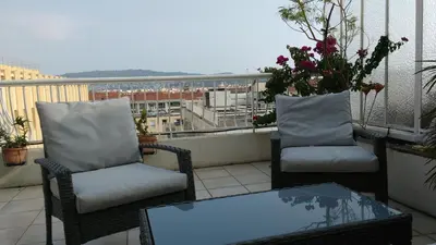 two chairs and a coffee table on a balcony at Val Roya Terrasse in Nice