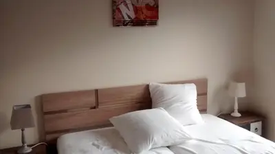 a bedroom with a bed with white sheets and pillows at Val Roya Terrasse in Nice
