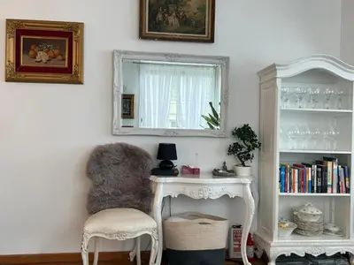 a room with a chair and a mirror and a table at Endless Stunning Mediterranean Sea Views Promenade Des Anglais in Nice