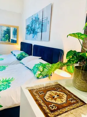 a bedroom with a bed and a table with a plant at Endless Stunning Mediterranean Sea Views Promenade Des Anglais in Nice