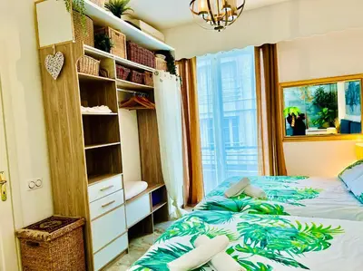 a bedroom with a bed and a book shelf at Endless Stunning Mediterranean Sea Views Promenade Des Anglais in Nice