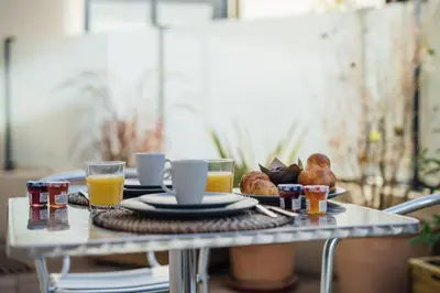 a table with a breakfast of orange juice and croissants at Le Foch in Nice