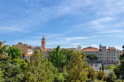 a view of a city with trees and buildings at GRAND HÔTEL Golden Square 3 min to Beach Green Corridor View AC in Nice