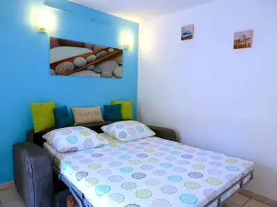 a bedroom with a bed and a blue wall at Studios Nice French Riviera in Nice