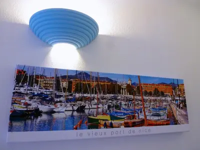 a picture of a marina with a light on a wall at Studios Nice French Riviera in Nice