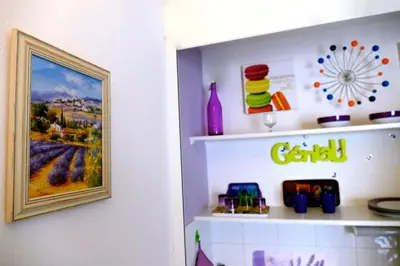 a shelf in a room with a painting on the wall at Studios Nice French Riviera in Nice