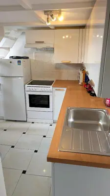 a kitchen with white appliances and a sink at CondoNice in Nice