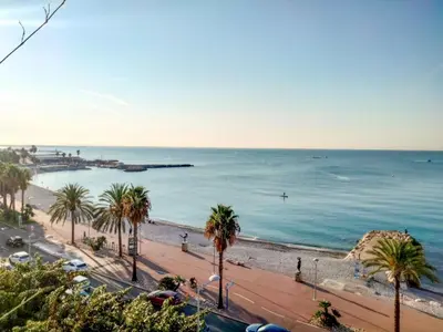 a room with a balcony with a table and chairs at Apartment L'Angelina-1 by Interhome in Cros-de-Cagnes