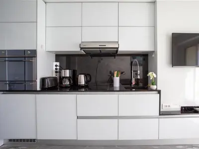 a kitchen and living room with a table and a couch at Apartment L'Angelina-1 by Interhome in Cros-de-Cagnes