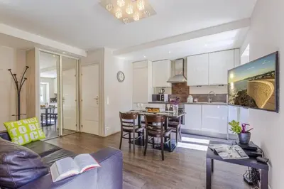 a living room and kitchen with a couch and a table at MY CASA - JOFFRE 9 - Near Masséna Square - Terrace in Nice