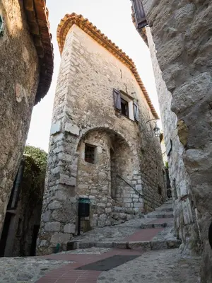 an old stone building with stairs in an alley at Eze Monaco middle of old town of Eze Vieux Village Romantic Hideaway with spectacular sea view in Èze