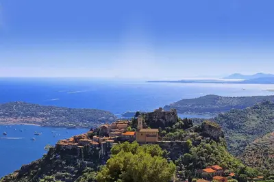 a monastery on top of a mountain near the water at Eze Monaco middle of old town of Eze Vieux Village Romantic Hideaway with spectacular sea view in Èze