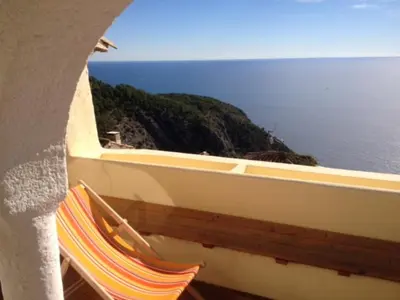 a couple of chairs sitting next to a boat at Eze Monaco middle of old town of Eze Vieux Village Romantic Hideaway with spectacular sea view in Èze