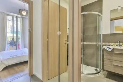 a bathroom with a glass shower and a sink at MY CASA - FRANCE 82 D - 2 rooms - Terrace - 1 min to the Sea in Nice
