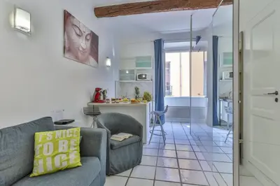 a living room with a couch and a kitchen at MY CASA - MARI 117 - City Center in Nice