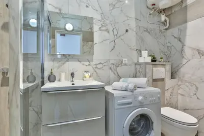 a bathroom with a washing machine and a sink at MY CASA - MARI 117 - City Center in Nice