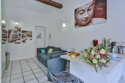 a living room with a table with flowers on it at MY CASA - MARI 117 - City Center in Nice