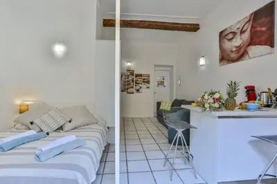 a living room and a kitchen with a couch at MY CASA - MARI 117 - City Center in Nice