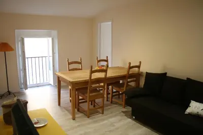 a living room with a table and chairs and a couch at Apartment Lisa Acropolis Garibaldi in Nice