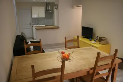 a dining room with a wooden table and chairs at Apartment Lisa Acropolis Garibaldi in Nice