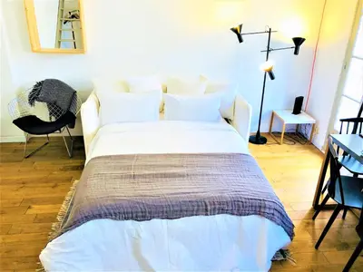 a bedroom with a large bed with white sheets at Malonat Duplex - Old Town in Nice
