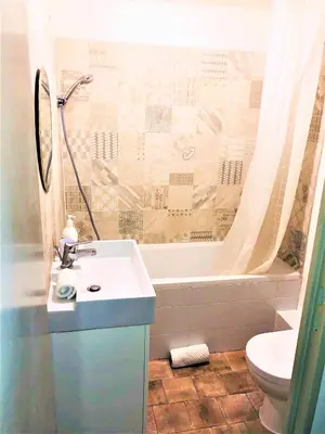 a bathroom with a sink and a tub and a toilet at Malonat Duplex - Old Town in Nice