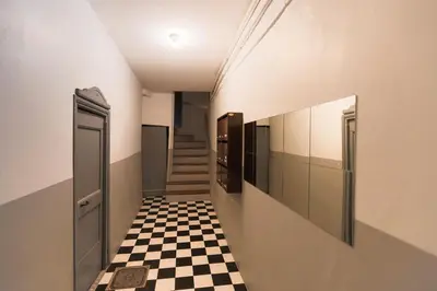 a hallway with a black and white checkered floor at Moulin -Old Town in Nice