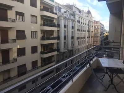 a balcony of a building with a table on it at Le Palais Martine in Nice