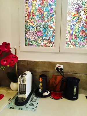 a kitchen counter with a toaster and a stained glass window at Appartment Le Charme du Bourgeois in Nice
