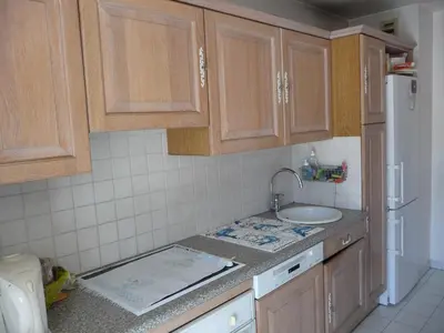a kitchen with wooden cabinets and a sink at Chambre chez l'habitant Nice Baie des Anges in Nice
