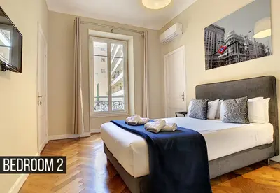 a bedroom with a large bed with a large window at Nestor&Jeeves - PALAIS ARNULF - Central - Very close sea in Nice