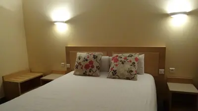 a bedroom with a bed with two pillows at Residence Club Inn in Nice